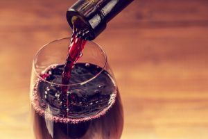 Pouring red wine into the glass 